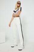 Спортивні штани Fila жіночі колір бежевий з аплікацією