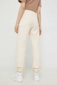Спортивні штани Champion жіночі колір бежевий з аплікацією Спортивні штани Champion жіночі колір бежевий з аплікацією