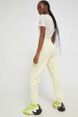 Спортивні штани Champion жіночі колір жовтий з аплікацією Спортивні штани Champion жіночі колір жовтий з аплікацією