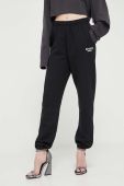 Бавовняні спортивні штани Rotate колір чорний з аплікацією
