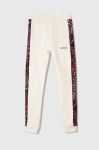 Дитячі бавовняні штани Guess колір бежевий візерунок Дитячі бавовняні штани Guess колір бежевий візерунок
