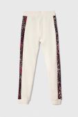 Дитячі бавовняні штани Guess колір бежевий візерунок
