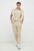 Бавовняні спортивні штани Fila колір бежевий однотонні (3023086)